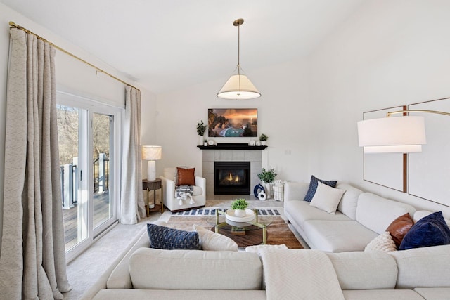 living room featuring lofted ceiling and a fireplace