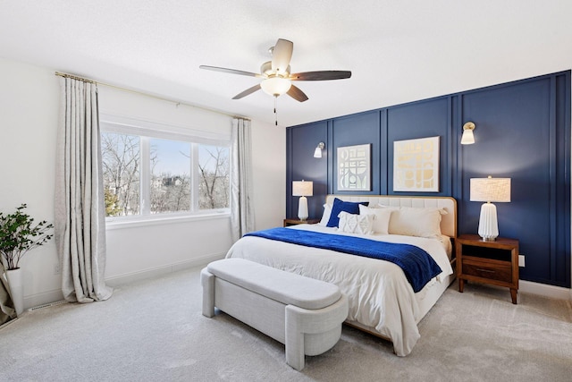 bedroom featuring baseboards, light carpet, and ceiling fan