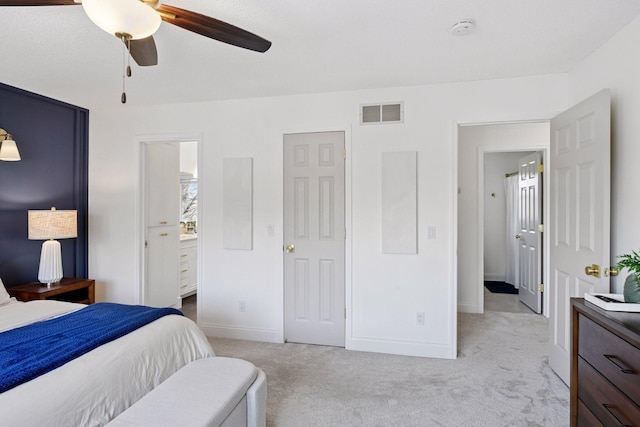 bedroom featuring visible vents, a ceiling fan, connected bathroom, baseboards, and light colored carpet