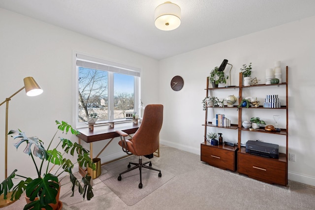 office area featuring light carpet and baseboards