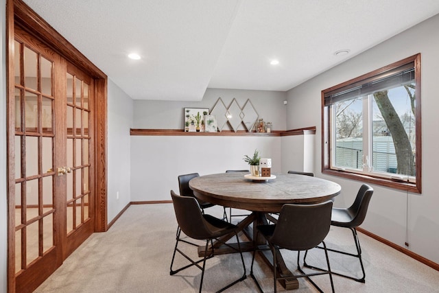 dining room featuring recessed lighting, light colored carpet, and baseboards