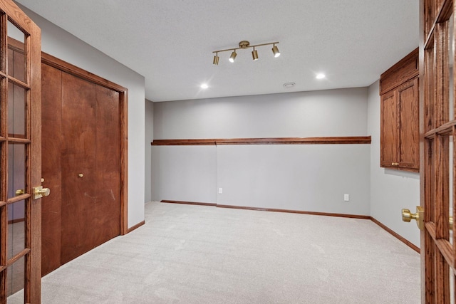 interior space with recessed lighting, a textured ceiling, baseboards, and carpet