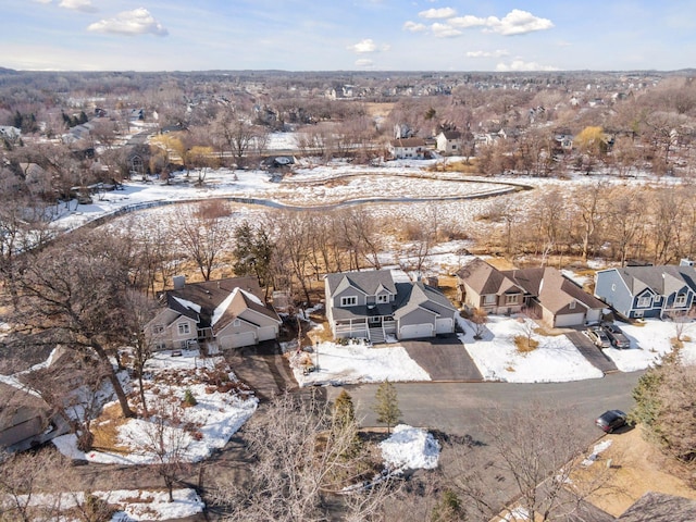 snowy aerial view with a residential view