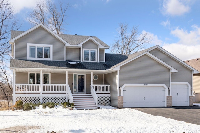 view of front of house featuring aphalt driveway, a porch, a garage, and roof with shingles