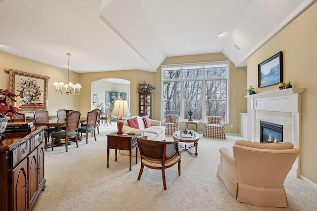 living room with light colored carpet, lofted ceiling, and a chandelier