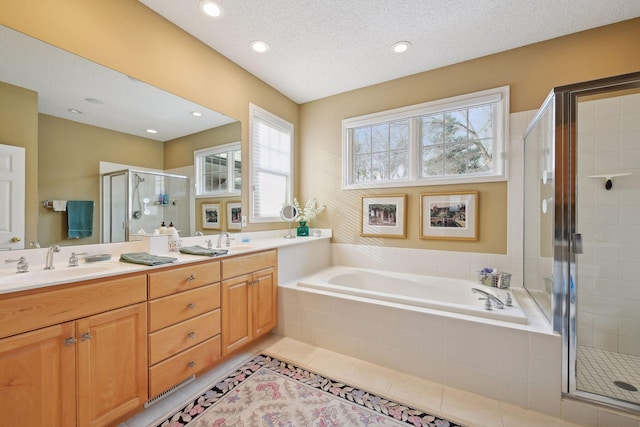 bathroom featuring tile patterned floors, plus walk in shower, vanity, and a textured ceiling