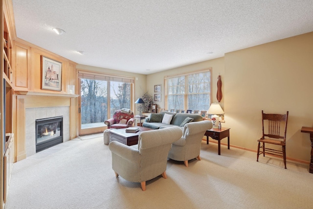 living room with a textured ceiling, light colored carpet, and a fireplace