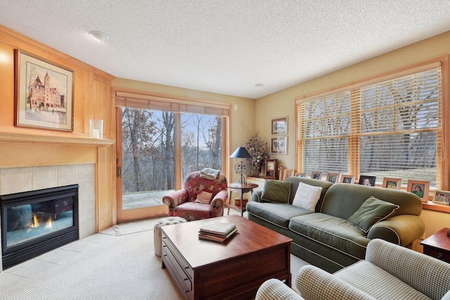 tiled living room featuring a tile fireplace and a textured ceiling