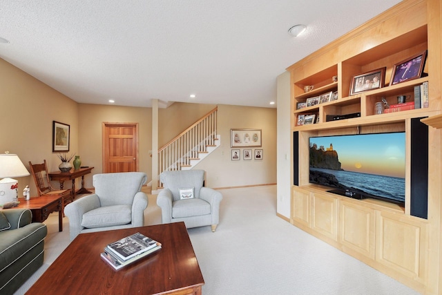 living room with built in features, light colored carpet, and a textured ceiling