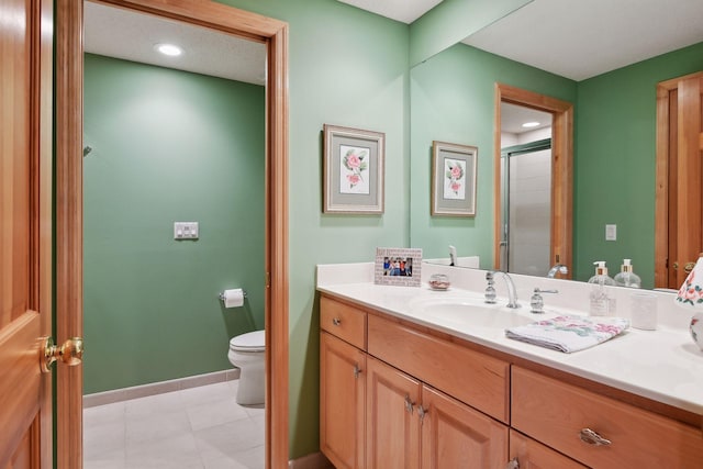 bathroom featuring an enclosed shower, vanity, and toilet