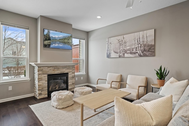 living room featuring a fireplace, dark hardwood / wood-style floors, and ceiling fan