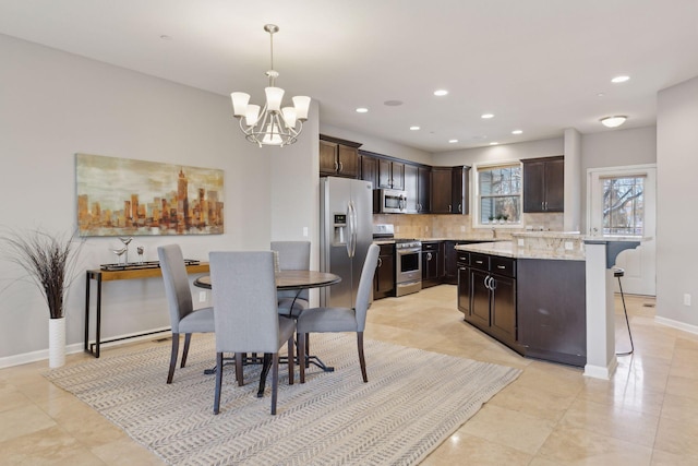 dining area featuring light tile patterned flooring and a chandelier