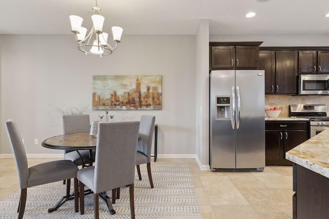 tiled dining space featuring a chandelier