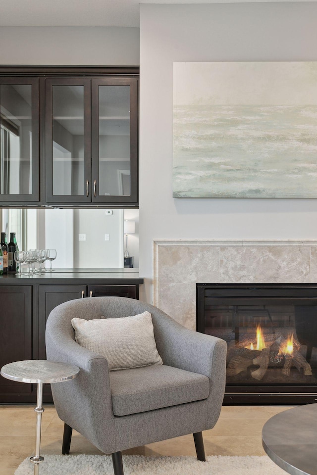 living area featuring light wood-type flooring and a high end fireplace