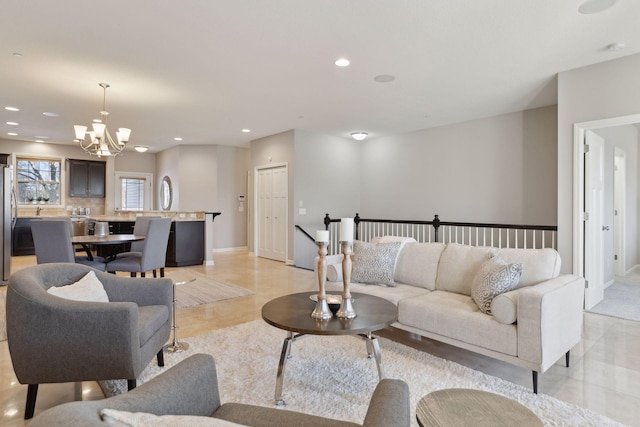 tiled living room featuring an inviting chandelier