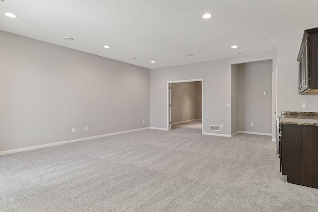 unfurnished living room with light carpet