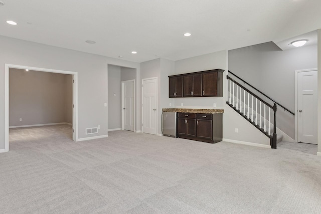 unfurnished living room featuring light carpet