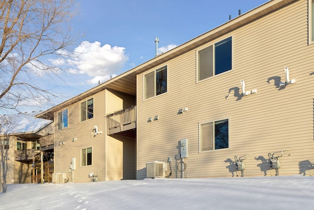 back of house featuring central AC unit and a balcony