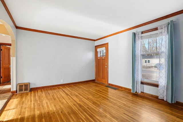 unfurnished room with light hardwood / wood-style flooring and ornamental molding