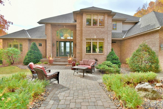 rear view of property featuring french doors and a patio