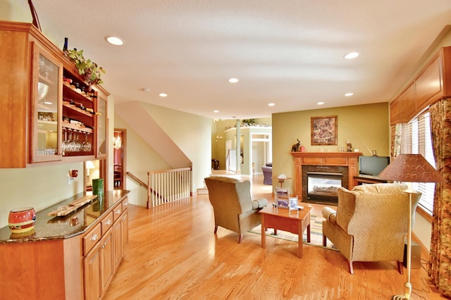 living room featuring light hardwood / wood-style flooring and a high end fireplace