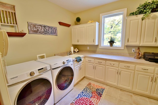 laundry room with washer and clothes dryer, cabinets, light tile patterned floors, and sink