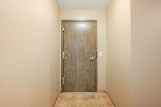 doorway to outside featuring a textured ceiling