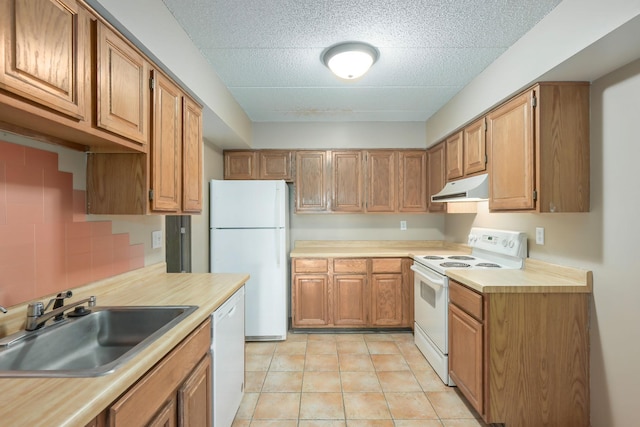 kitchen with decorative backsplash, white appliances, sink, and light tile patterned floors