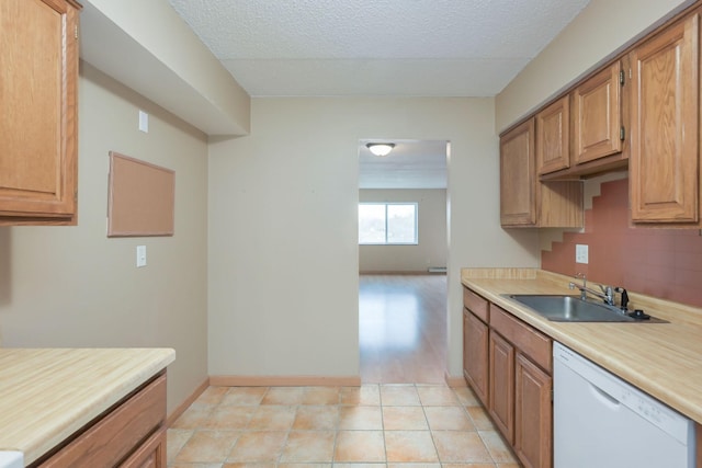 kitchen featuring dishwasher, a textured ceiling, and sink