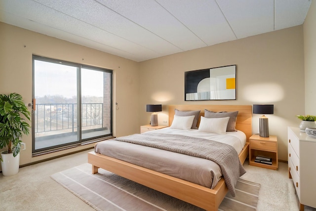 bedroom featuring light carpet and access to exterior