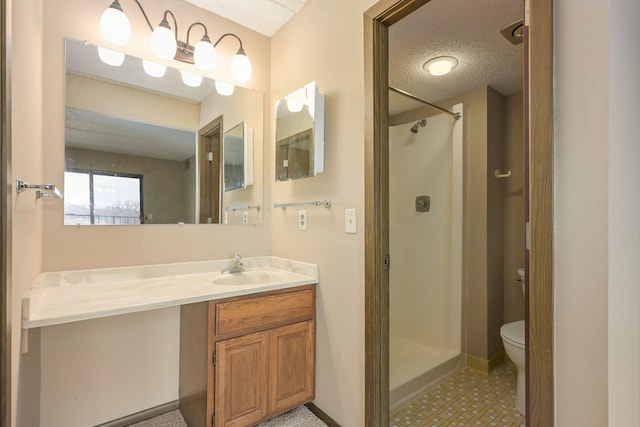 bathroom with vanity, a textured ceiling, toilet, and walk in shower