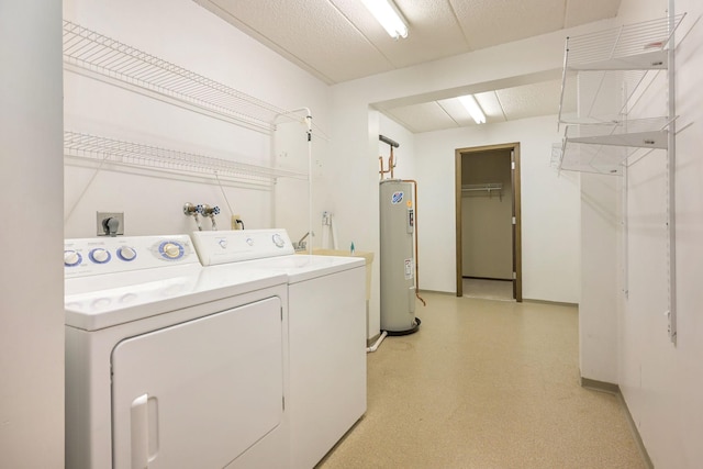 laundry room featuring washing machine and clothes dryer and water heater