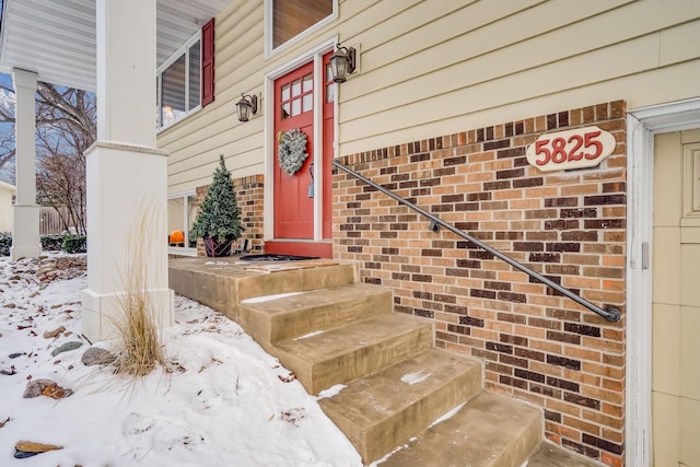 view of snow covered property entrance