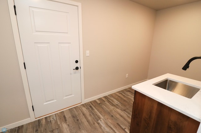 interior space with hardwood / wood-style floors and sink