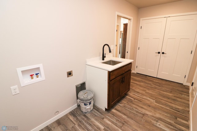 clothes washing area featuring hookup for a washing machine, dark hardwood / wood-style floors, electric dryer hookup, and sink