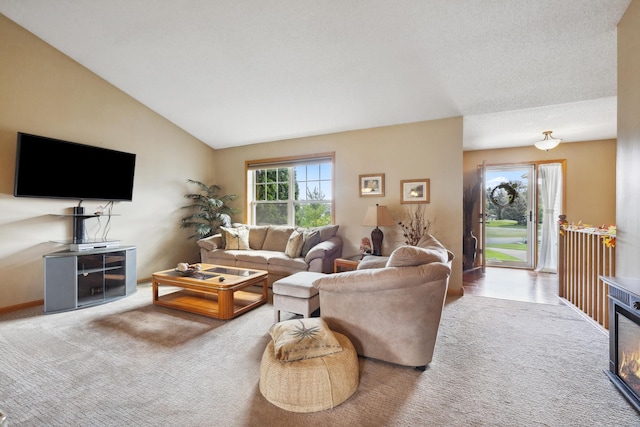 living room featuring lofted ceiling and carpet flooring