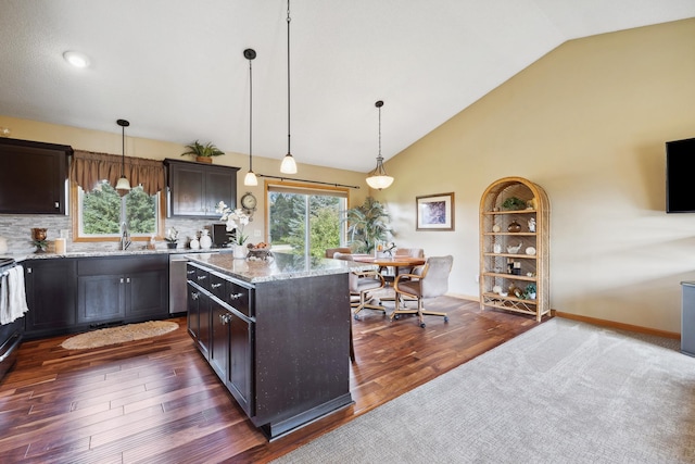 kitchen with dark brown cabinetry, light stone countertops, a kitchen island, dark hardwood / wood-style flooring, and decorative light fixtures