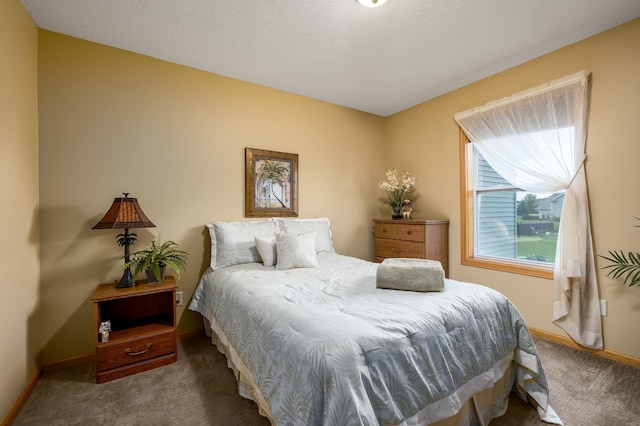 bedroom featuring a textured ceiling and carpet