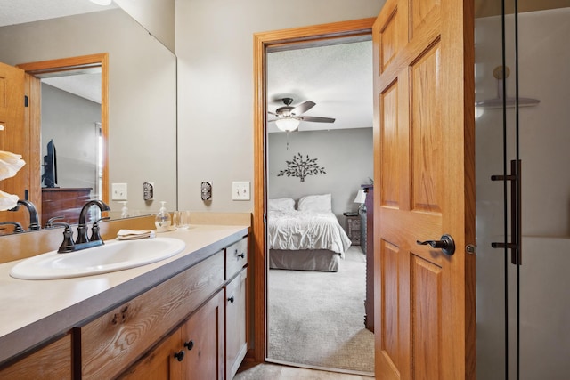 bathroom featuring ceiling fan, vanity, and a textured ceiling