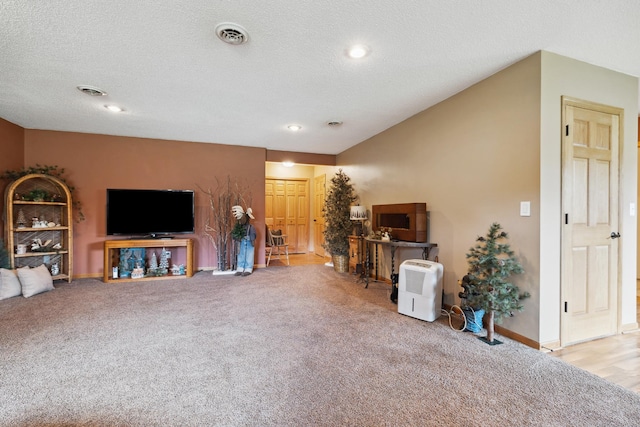 living room featuring light colored carpet and a textured ceiling