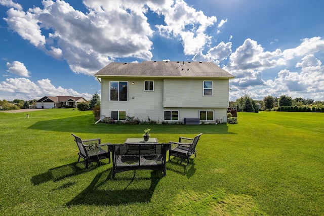 rear view of property with a lawn