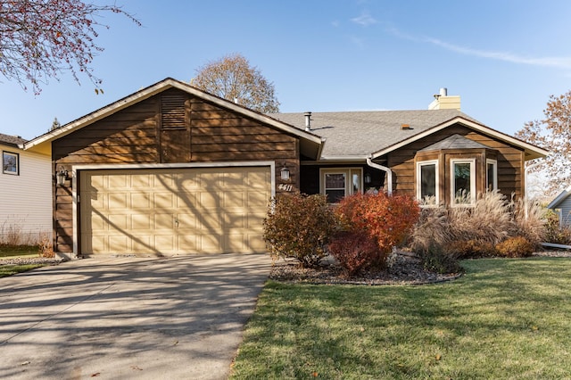 ranch-style house with an attached garage, concrete driveway, roof with shingles, a chimney, and a front yard