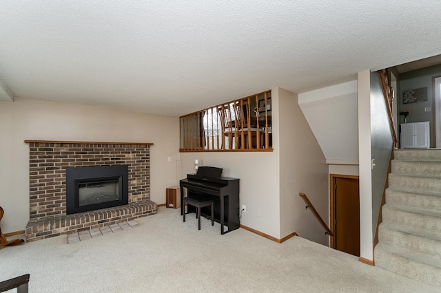 carpeted living area with a fireplace, baseboards, and a textured ceiling