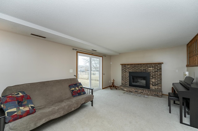 living area with light carpet, baseboards, visible vents, a textured ceiling, and a brick fireplace