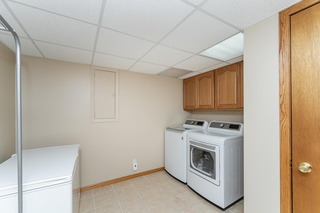 laundry area featuring cabinet space, washing machine and dryer, and baseboards