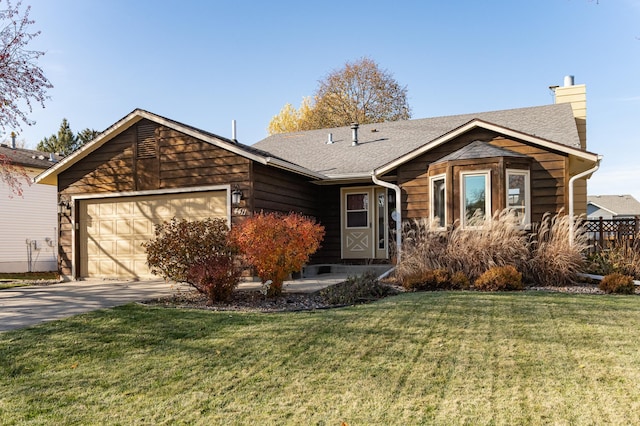 ranch-style house featuring an attached garage, concrete driveway, roof with shingles, a chimney, and a front yard