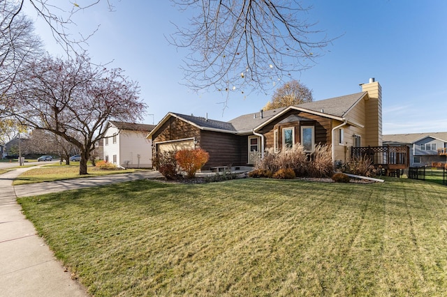 view of front facade featuring driveway, a chimney, an attached garage, and a front yard