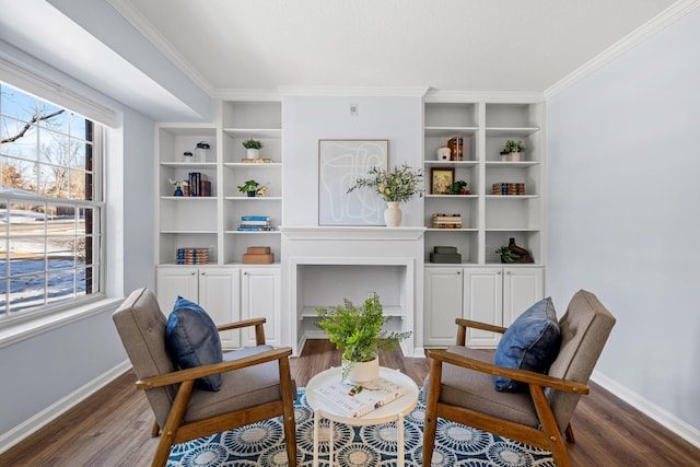 sitting room featuring crown molding, built in features, and dark hardwood / wood-style flooring