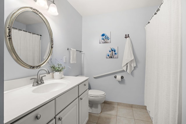 bathroom featuring tile patterned floors, vanity, and toilet