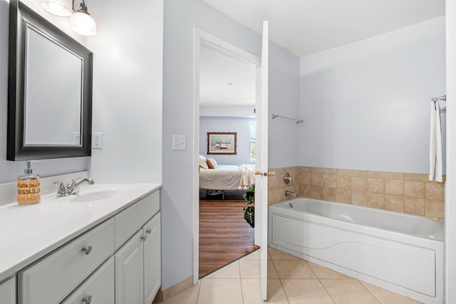 bathroom with a bathtub, tile patterned flooring, and vanity